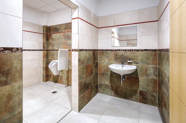 Stěny v prostoru toalet zkrášlují obkládačky Rush s kovovým vzhledem.