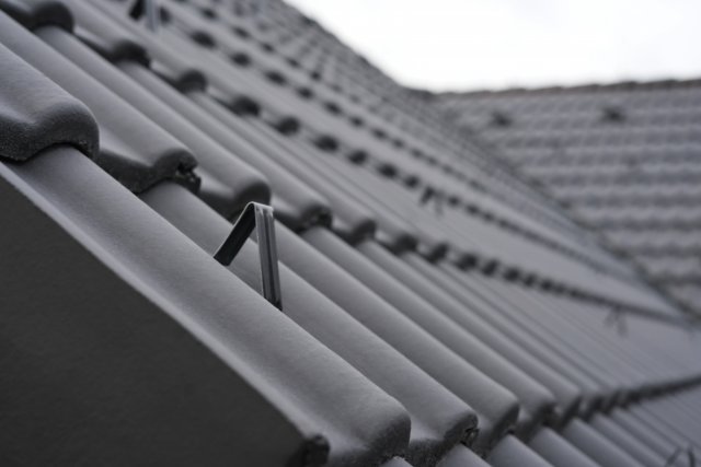 Detail protisněhového háku na krytině KM Beta v povrchové úpravě Samet a černé barvě